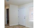 View of entryway showcasing ceramic tile flooring, neutral walls, glass block window, and a white door at 12224 N Gambel Dr, Fountain Hills, AZ 85268