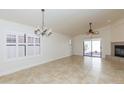 Spacious living room featuring neutral walls, a fireplace, ceramic tile flooring, and a sliding glass door at 12224 N Gambel Dr, Fountain Hills, AZ 85268
