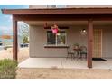 Relax on the covered porch with cozy seating, perfect for enjoying a quiet morning at 16350 N Desert Sage St, Surprise, AZ 85378