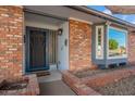 Inviting front entrance with brick accents, storm door and brick planter at 1767 W Kiowa Ave, Mesa, AZ 85202