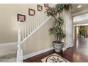 Grand entryway featuring a staircase, wood floors with marble inlay, and an elegant plant display at 20821 W Ridge Rd, Buckeye, AZ 85396