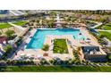 A community pool area with ample seating, shade structures, and well-maintained landscaping at 23282 S 229Th Pl, Queen Creek, AZ 85142
