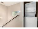Convenient laundry area located near the stairs, featuring a stacked washer and dryer unit at 2450 W Glenrosa Ave # 41, Phoenix, AZ 85015