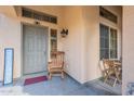 Inviting front porch with a rocking chair, stylish lantern, and a 'WELCOME' sign at 2528 W Mericrest Way, San Tan Valley, AZ 85144