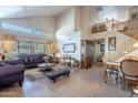 Spacious living room with high ceilings, tile flooring, and abundant natural light at 2528 W Mericrest Way, San Tan Valley, AZ 85144