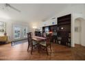 Cozy dining area with wooden table and chairs next to a built-in bookcase at 3777 N 162Nd Ave, Goodyear, AZ 85395