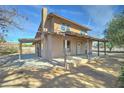 Rear view of a charming home featuring a covered porch and yard at 4302 W Dobbins Rd, Laveen, AZ 85339