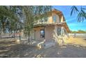 Side view of a home with a covered porch and a spacious yard at 4302 W Dobbins Rd, Laveen, AZ 85339