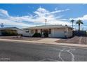 Charming single-story home featuring a two-car garage, well-maintained landscaping, and desert rock front yard at 5429 E Billings St, Mesa, AZ 85205