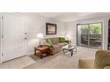 Cozy living room with neutral tones, a comfortable sofa, and a sliding glass door to the balcony at 5877 N Granite Reef Rd # 2203, Scottsdale, AZ 85250