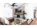 Comfortable living room showcasing a statement wall, modern fireplace, and comfortable leather seating at 6621 E Sharon Dr, Scottsdale, AZ 85254