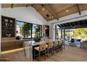Beautiful kitchen with a large island with seating, wood cabinets, expansive window and view to the outdoor patio at 7508 E Laredo Ln, Scottsdale, AZ 85250