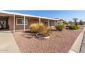 Charming home with desert landscaping and covered carport, creating a welcoming curb appeal at 7714 E Calypso Ave, Mesa, AZ 85208