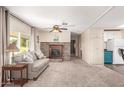 Cozy living room with fireplace, neutral tones, and sliding glass doors for natural light at 7714 E Calypso Ave, Mesa, AZ 85208