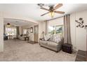 Spacious living room with ample seating and large windows, offering plenty of natural light at 7714 E Calypso Ave, Mesa, AZ 85208