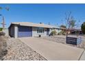 Well-kept home featuring a two-car garage and a neatly maintained front yard at 8150 E Mitchell Dr, Scottsdale, AZ 85251