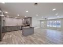 Open-concept kitchen with gray cabinetry, an island, and stainless steel appliances at 8150 E Mitchell Dr, Scottsdale, AZ 85251