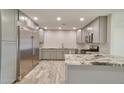Modern kitchen featuring stainless steel appliances, granite counters, and gray cabinets at 8150 E Mitchell Dr, Scottsdale, AZ 85251