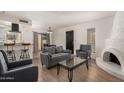 Cozy living room with neutral tones, a decorative fireplace, and comfortable seating arrangement at 8841 S 48Th St # 1, Phoenix, AZ 85044