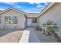 Inviting front entrance with a well-lit walkway, desert landscaping, and a neutral color scheme at 9609 E Monte Ave, Mesa, AZ 85209