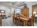 Elegant dining room with wooden furniture, Southwestern decor and views to other living spaces at 10545 E Texas Ave, Mesa, AZ 85212