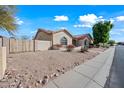 Charming home with desert landscaping, a terra cotta roof and a fenced side yard at 10895 E Mission Ln, Scottsdale, AZ 85259