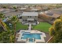 Aerial view of a manicured lawn, sparkling pool, and outdoor living space at 1180 E Ibis St, Gilbert, AZ 85297