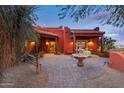 Outdoor patio area with fountain, table, and seating, perfect for relaxation and entertainment at 14215 E Calle De Las Estrellas Dr, Scottsdale, AZ 85262