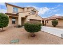 Charming two-story home featuring a desert landscape, brown garage door and a classic design at 16789 W Moreland St, Goodyear, AZ 85338