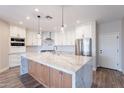 Bright kitchen with a large island, stainless appliances, and stylish pendant lighting at 18430 E Ashridge Dr, Queen Creek, AZ 85142