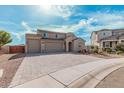 Charming two-story home featuring a three-car garage, desert landscaping and a paver driveway at 1997 E Brooklyn Dr, Casa Grande, AZ 85122