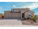 Charming two-story home featuring a three-car garage, desert landscaping and a paver driveway at 1997 E Brooklyn Dr, Casa Grande, AZ 85122