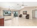 Open concept room featuring tile floors, vaulted ceiling, and glass doors leading to backyard at 20603 N Stonegate Dr, Sun City West, AZ 85375