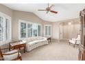 Bright living room with a vaulted ceiling, large windows with plantation shutters, and neutral carpet at 20603 N Stonegate Dr, Sun City West, AZ 85375