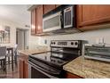 Close-up of a kitchen featuring granite countertops and modern stainless steel appliances at 2625 E Indian School Rd # 240, Phoenix, AZ 85016