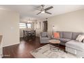 Comfortable living area featuring a gray sofa and chair, with stylish decor and wood flooring at 2625 E Indian School Rd # 240, Phoenix, AZ 85016