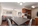 Open living space with a kitchen and dining area flowing into a cozy living room setup at 2625 E Indian School Rd # 240, Phoenix, AZ 85016