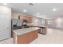 Open concept kitchen with stainless steel appliances and island at 274 W Kona Dr, Casa Grande, AZ 85122