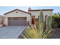 Charming single-story home featuring desert landscaping and a two-car garage at 29816 N 129Th Gln, Peoria, AZ 85383