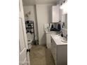 Well-lit bathroom featuring modern fixtures, white cabinetry, updated mirror, and neutral tiled flooring at 32628 N 163Rd Ave, Surprise, AZ 85387