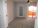 Light-filled bedroom with carpet flooring and sliding glass door to patio at 4303 E Cactus Rd # 331, Phoenix, AZ 85032