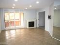 Bright living room featuring tile floors, fireplace, and sliding doors to a balcony at 4303 E Cactus Rd # 331, Phoenix, AZ 85032