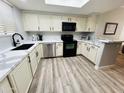 Well-lit kitchen featuring white cabinets, stainless steel appliances, and black hardware at 4925 E Desert Cove Ave # 117, Scottsdale, AZ 85254