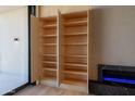 Built-in wood cabinets offer ample storage near the fireplace at 5000 N Camelback Ridge Dr # 304, Scottsdale, AZ 85251