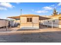 Cozy manufactured home with covered parking and manicured gravel landscaping at 535 S Alma School Rd # 60, Mesa, AZ 85210