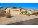 Single-story home with a two-car garage, neutral exterior, desert landscaping, and solar panels at 6442 W Cavedale Dr, Phoenix, AZ 85083