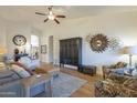 Spacious living room with wood floors, a ceiling fan, and decorative accents at 7149 E Quartz St, Mesa, AZ 85207