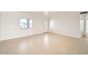 Bright, spacious living room with light tile flooring, a large window, and a white brick accent wall at 726 N 78Th St, Scottsdale, AZ 85257