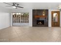 Bright living room with fireplace, sliding glass doors, and access to outdoor space at 7401 E Northland Dr # 1, Scottsdale, AZ 85251