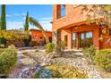 A peaceful stream flows alongside this home's outdoor patio at 7500 E Roy Rogers Rd, Scottsdale, AZ 85266